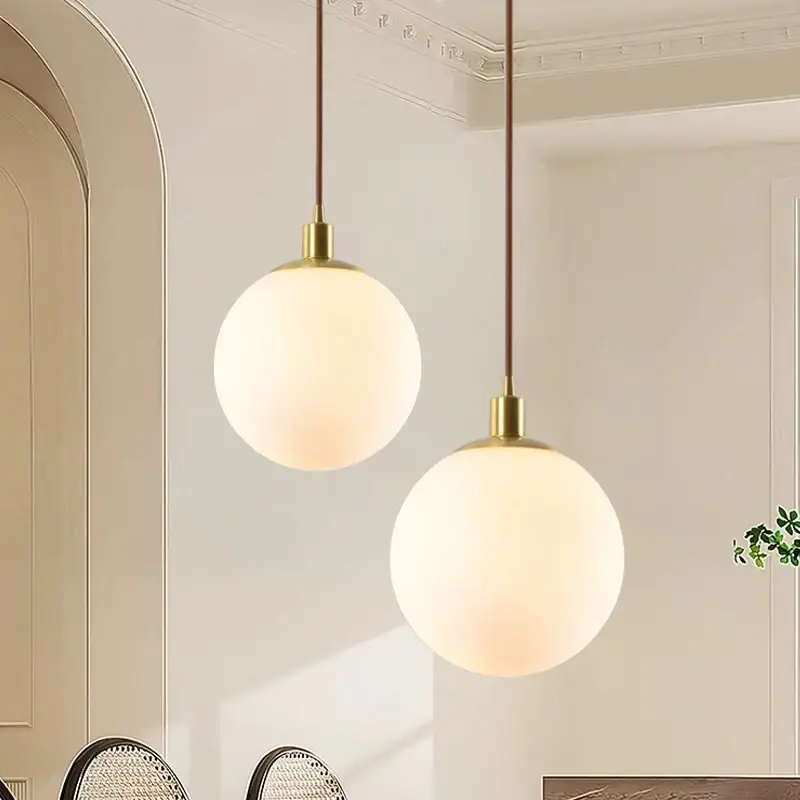 Minimalist brass pendant light with milky glass orb Usine Directe