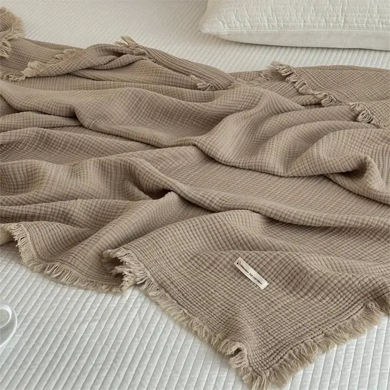 Soft cotton throw with pom-poms, plain style for living room Nouvelle Collection